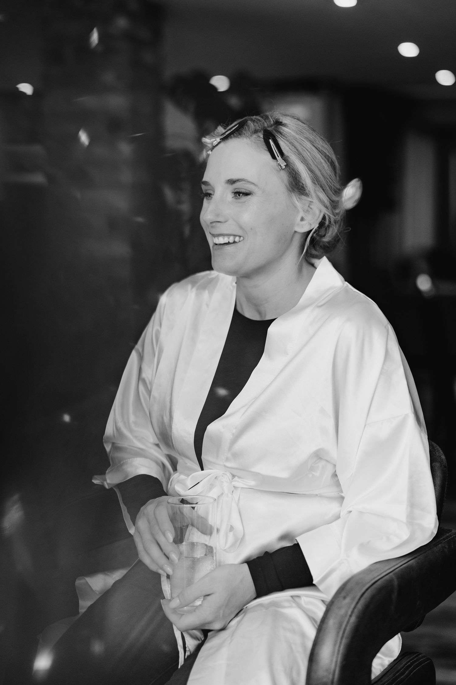 Black and white photo of joyful moments during wedding preparation with flowing white robe. Ballymagarvey Wedding photographer