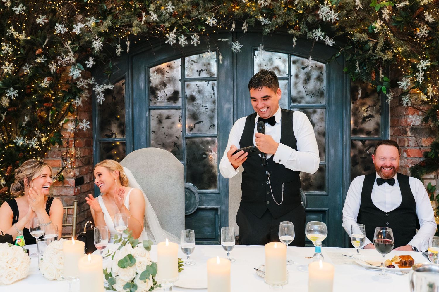 Wedding reception dinner scene with elegant table settings and floral decorations against blue doors. Ballymagarvey Wedding photographer
