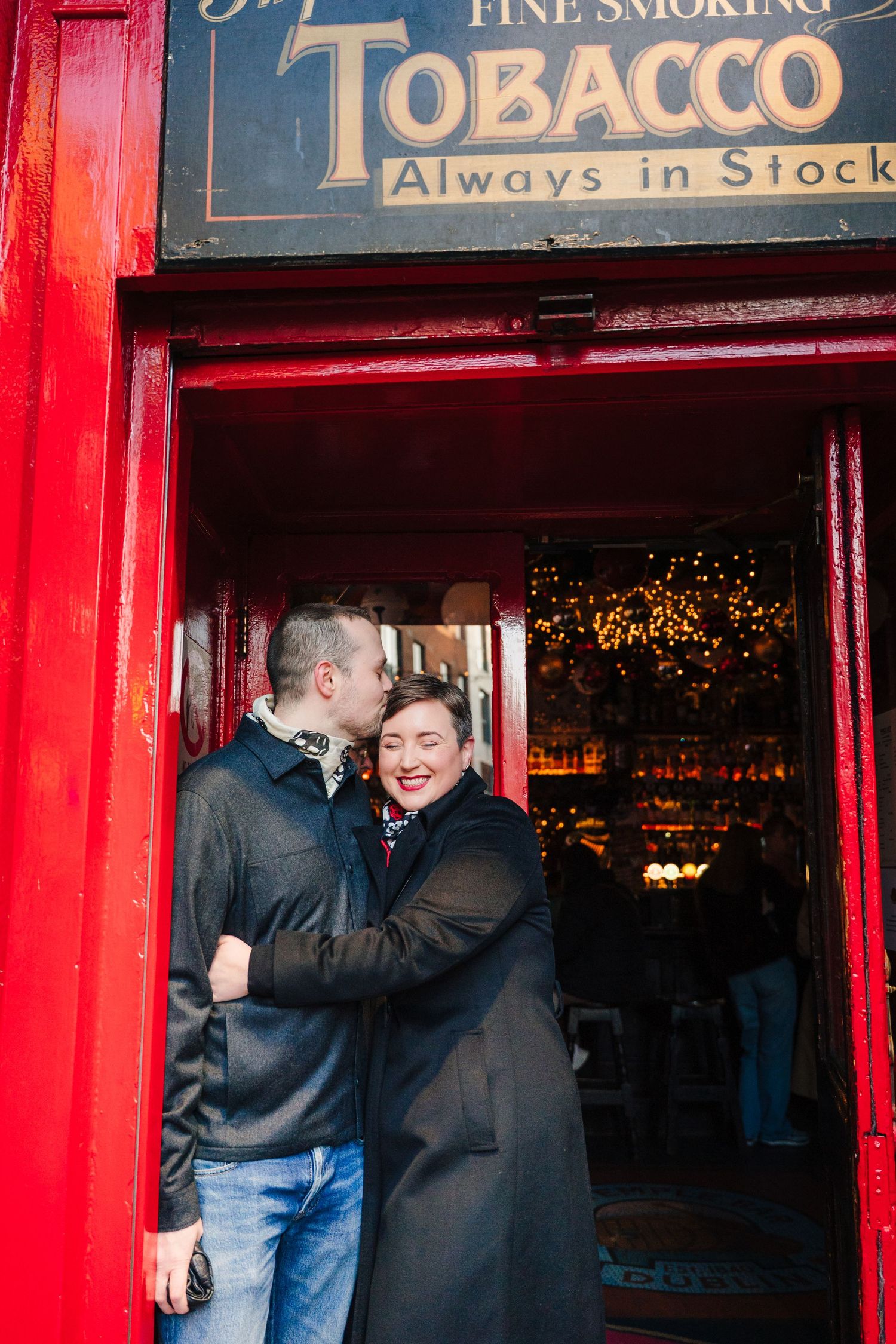 Family walking through Dublin city centre during a relaxed vacation photo session with a family photographer Dublin couple photoshoot temple