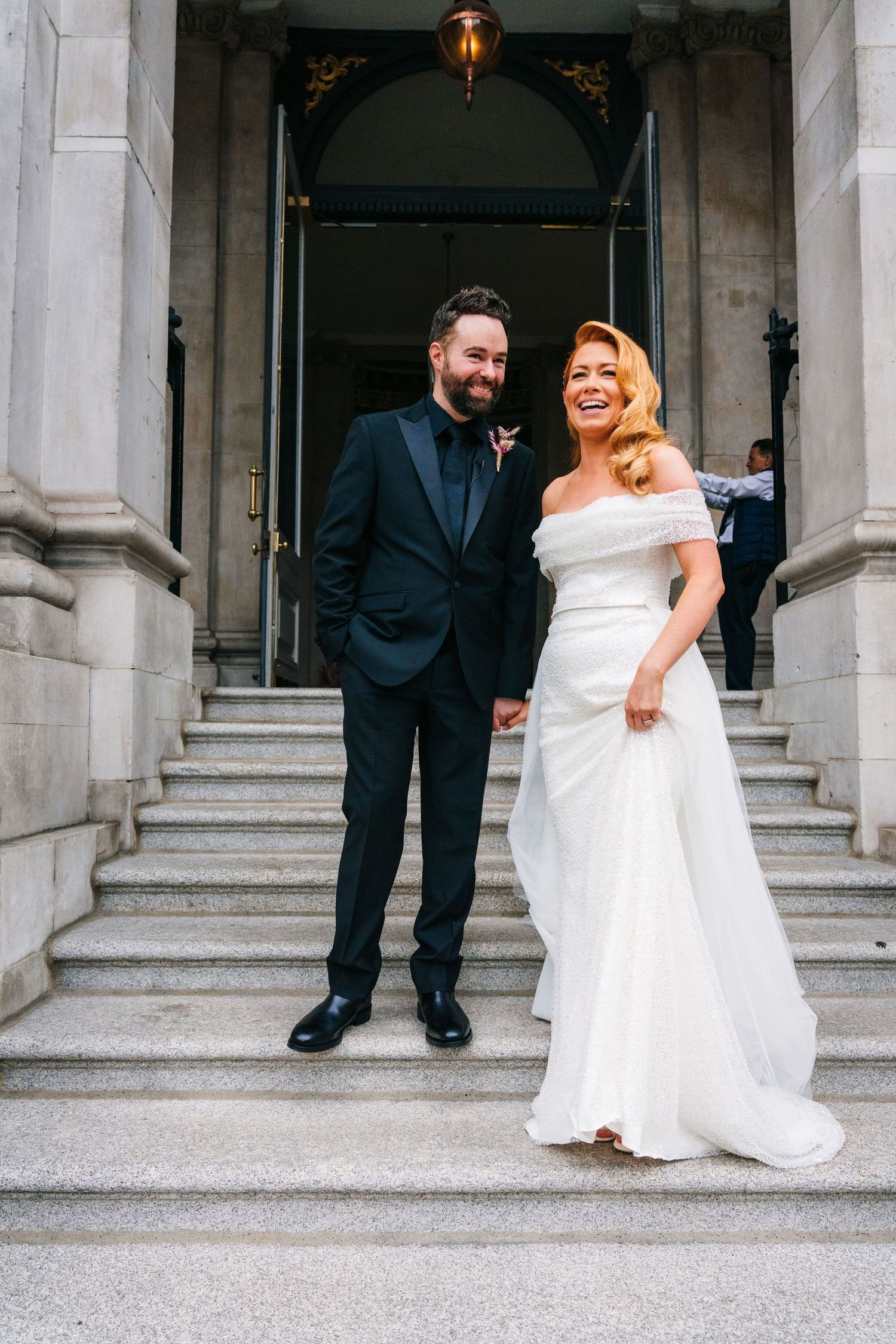 Sequence of newlyweds descending grand stone steps outside a historic building.  city hall dublin wedding photos