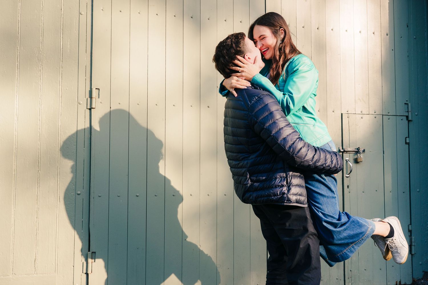 A sequence of four romantic silhouettes against a light wall showing a couple embracing and kissing. engagement photographer dublin