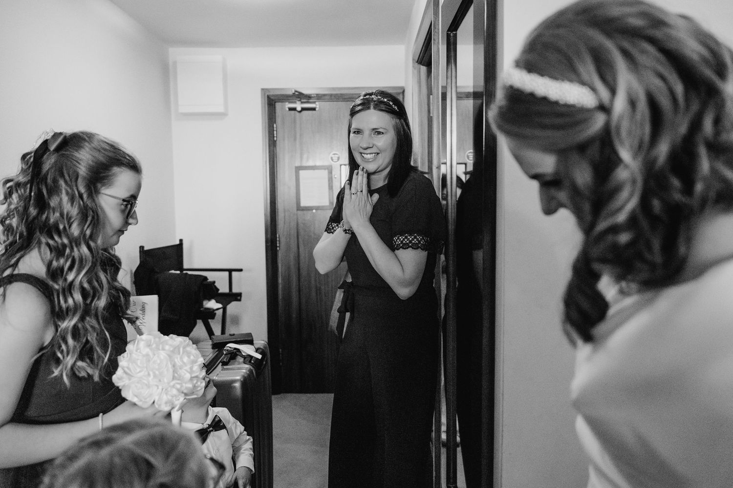 Black and white images showing wedding day preparations in a getting ready room.  Wedding PHOTOGRAPHER Trim Castle