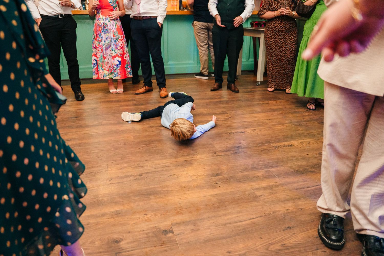 People dancing and celebrating on a wooden dance floor at a wedding reception. . Village Barn Tyrrellspass wedding photographer Ireland