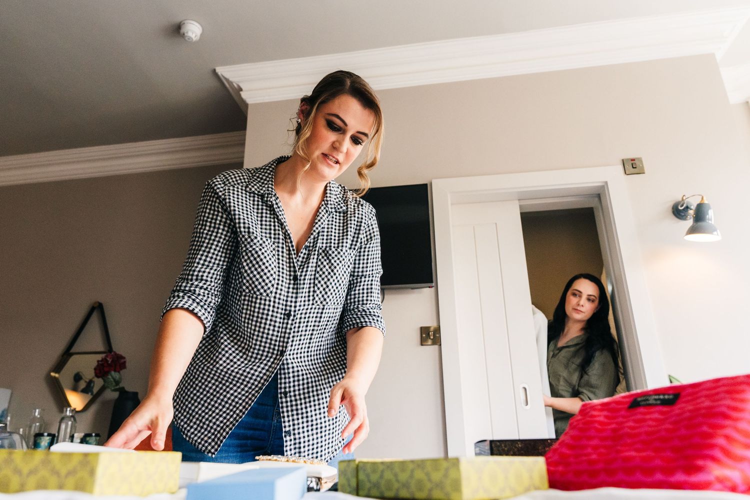 Getting ready scene in a bright room with people styling and preparing for a special event. House Dublin Wedding Photographer