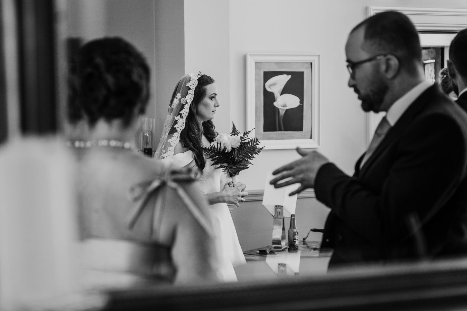 Poulaphouca Wedding photographer wicklow  Black and white candid photo of a bride and wedding guests in conversation during the reception.