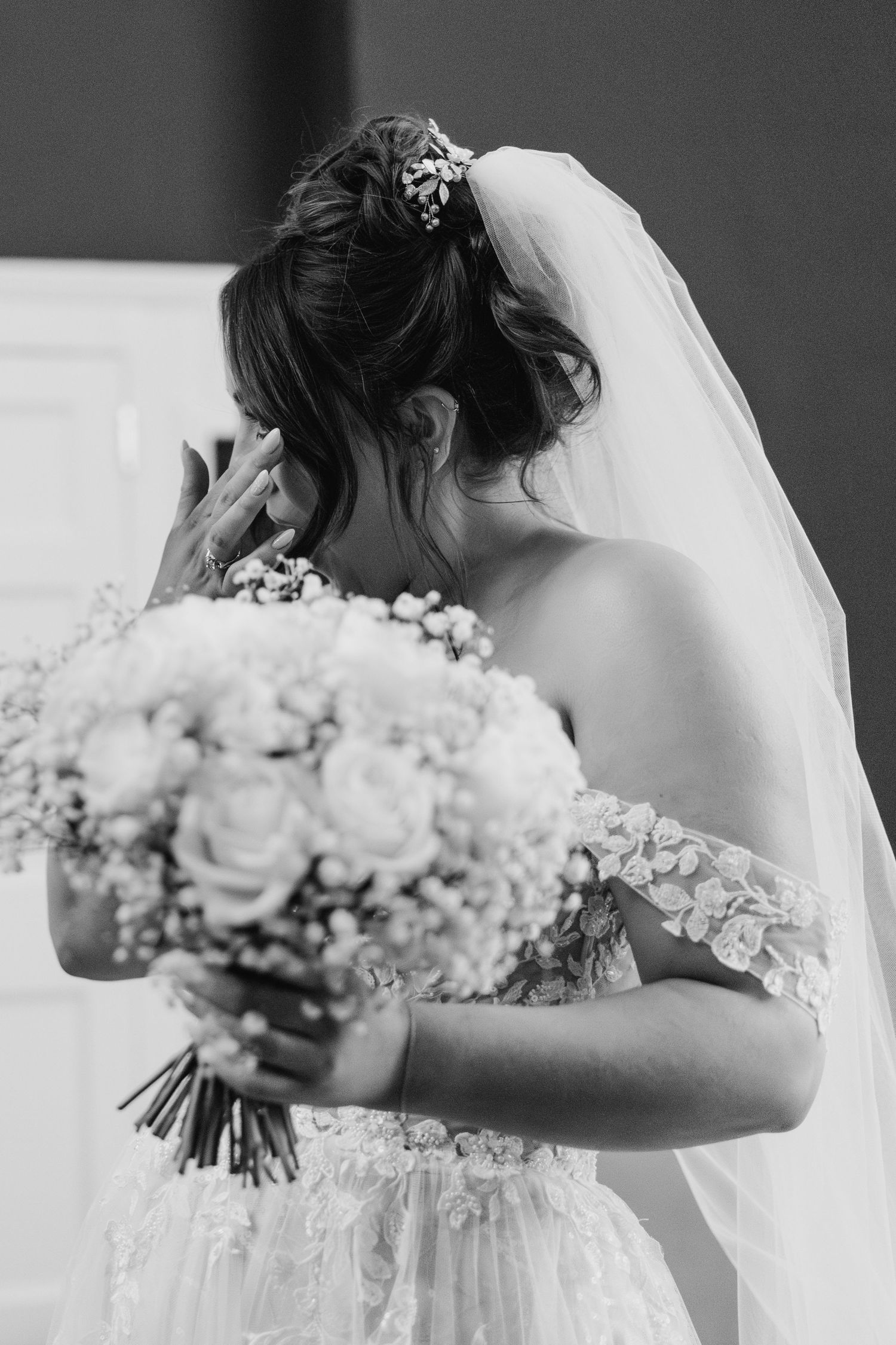 Black and white photo of a bride in a lace gown holding a lush floral bouquet.  Wedding PHOTOGRAPHER Dublin