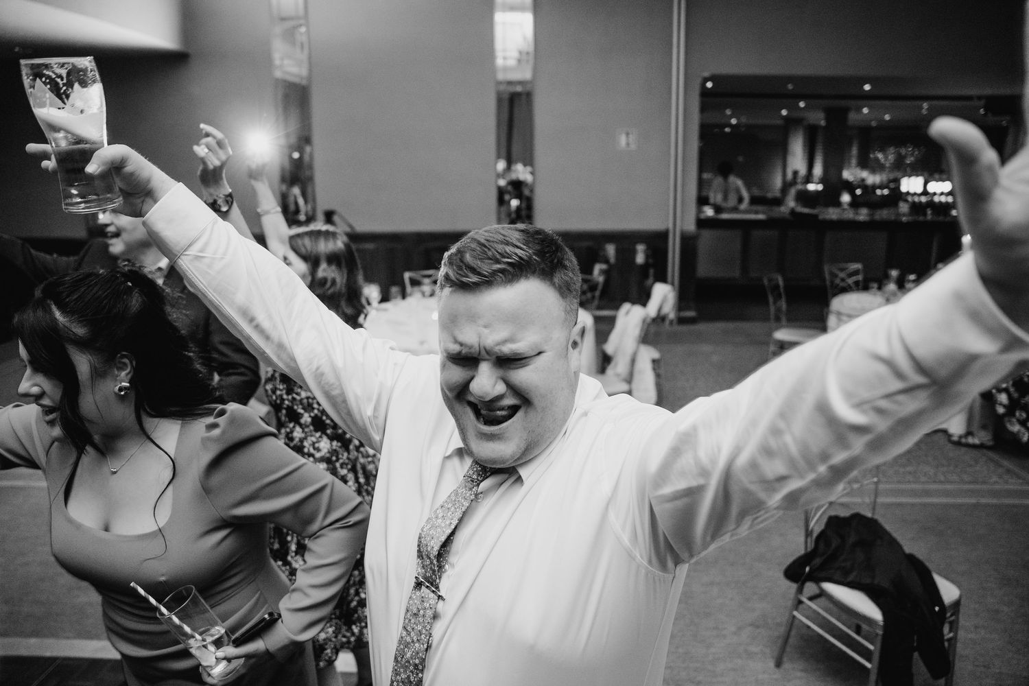 Black and white candid shots of guests dancing enthusiastically at a wedding reception.Wedding Photography Trim Castle Ireland
