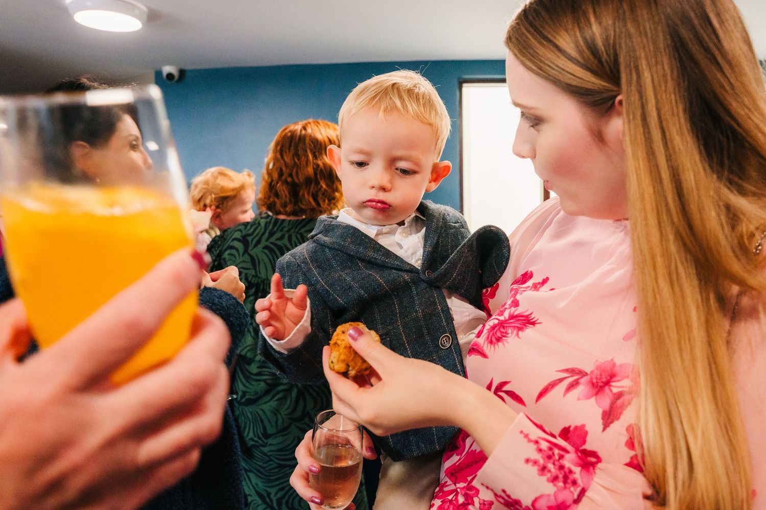 Children at a wedding reception wearing formal attire while holding beverages and snacks. Wedding Photography Trim Castle Ireland