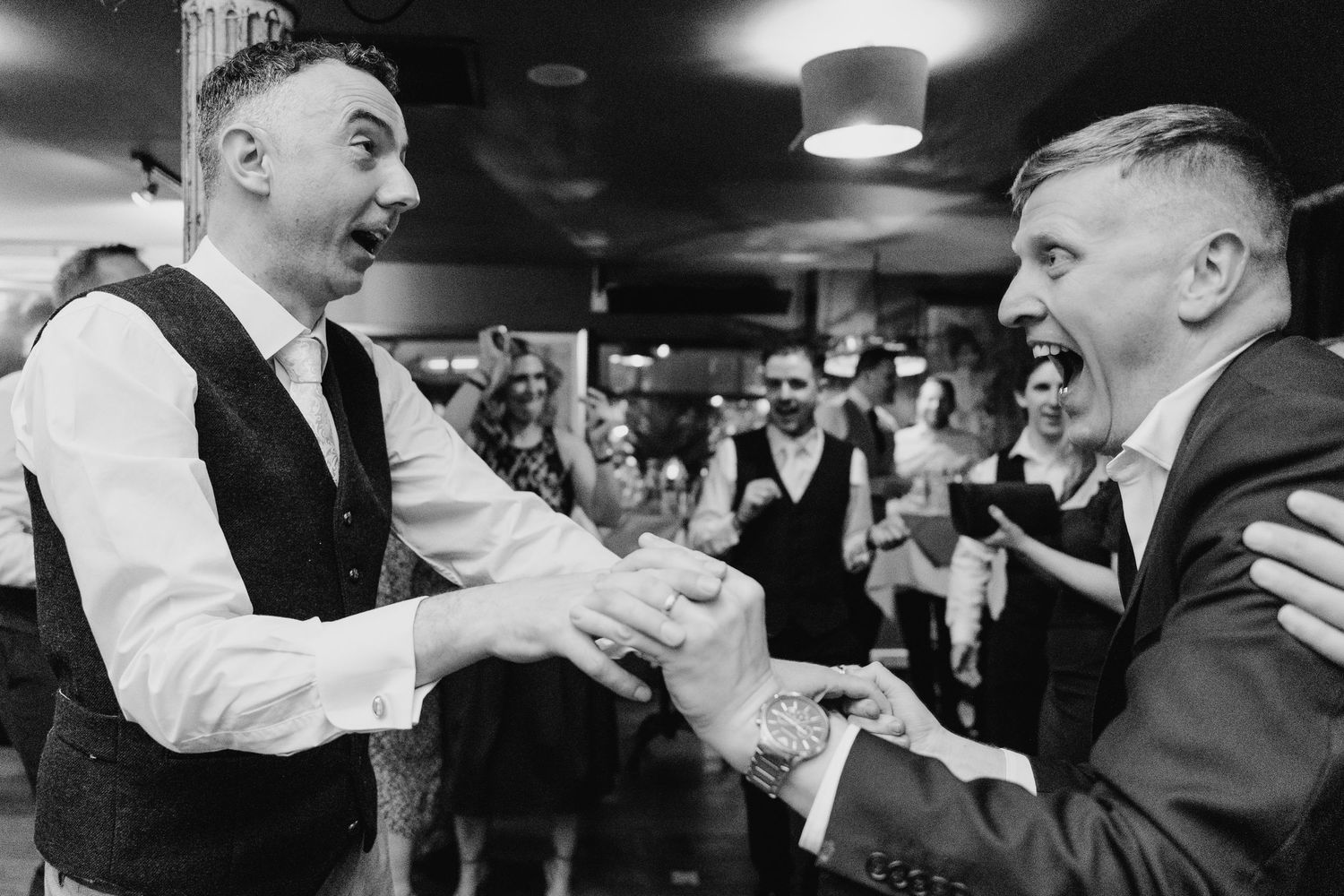 Black and white photo of lively dancing and celebrations at a wedding reception. Marco Pierre Dublin Wedding Photographer