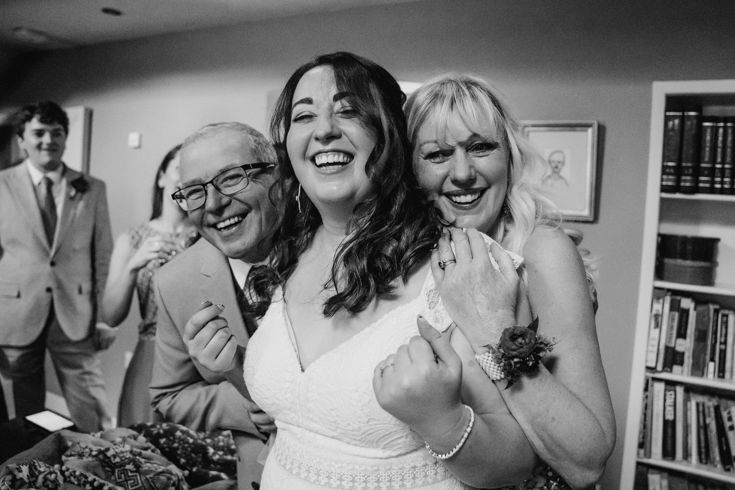 A series of candid black and white wedding party photos showing joyful moments and laughter. Wedding photographer Dublin