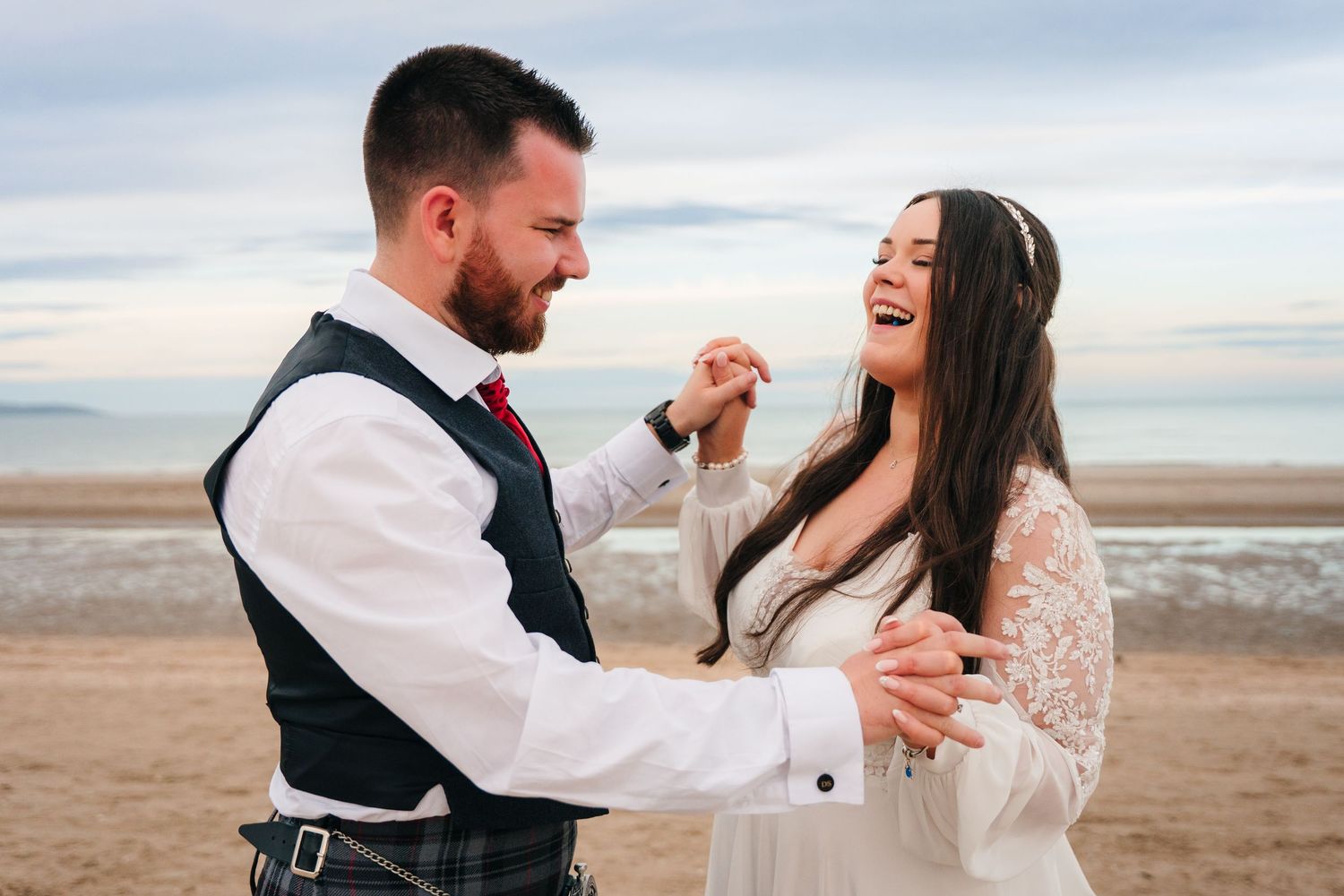 Joyful wedding couple sharing romantic moments on beach during sunset photo session. Portmarnock Hotel Wedding PHOTOGRAPHER Dublin