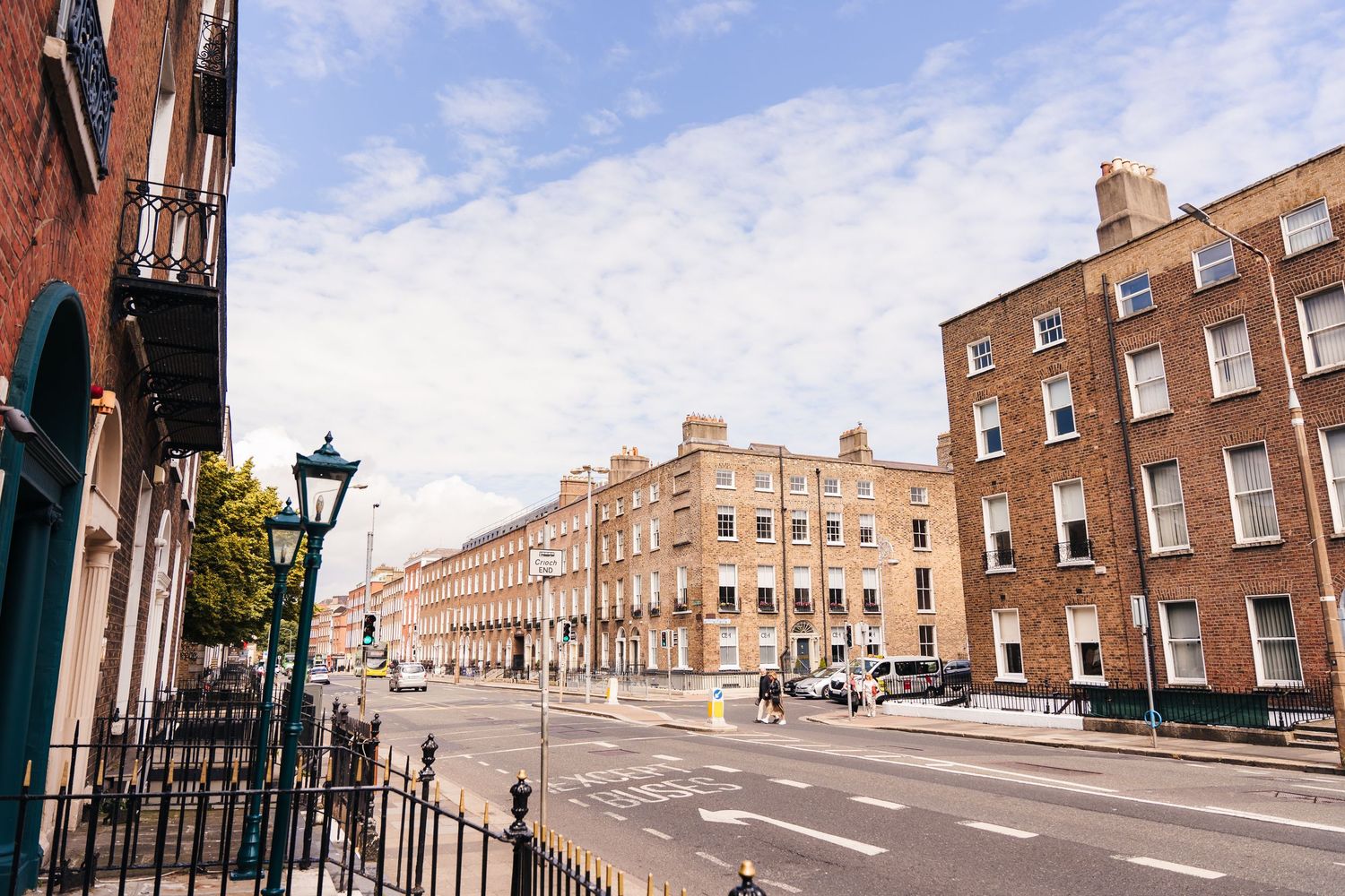 A panoramic view of historic brick buildings along a street with traditional lampposts. House Dublin Wedding Photographer