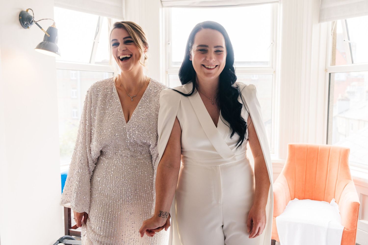 People celebrating together in a bright white interior room. House Dublin Wedding Photographer