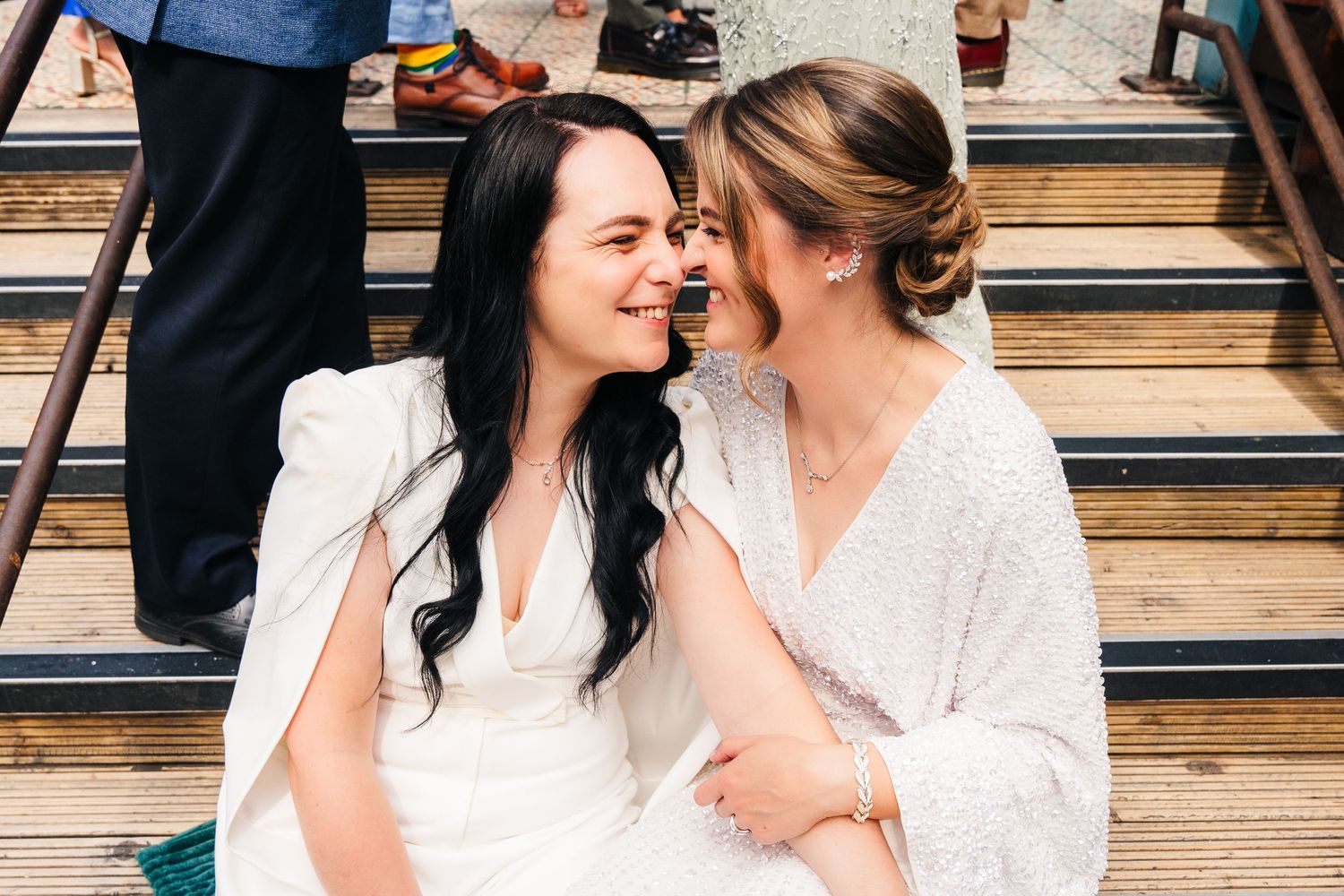 An intimate moment shared between two people during a celebration on wooden steps. House Dublin Wedding Photographer