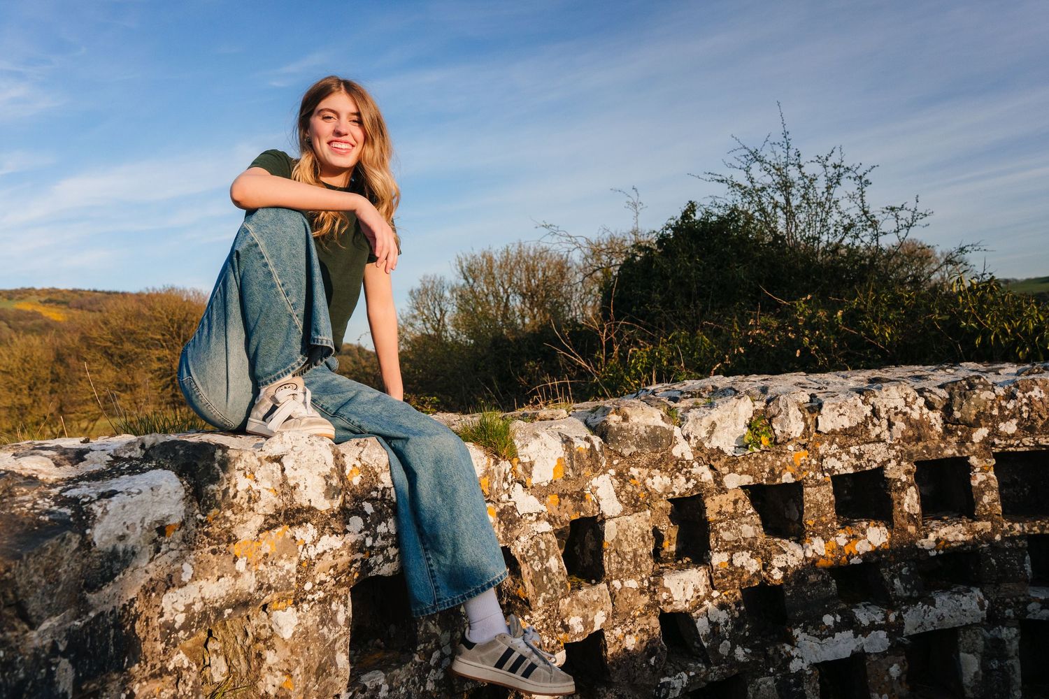 Couple enjoying a romantic photoshoot at ancient castle ruins during golden hour sunset. Photographer Ireland dublin