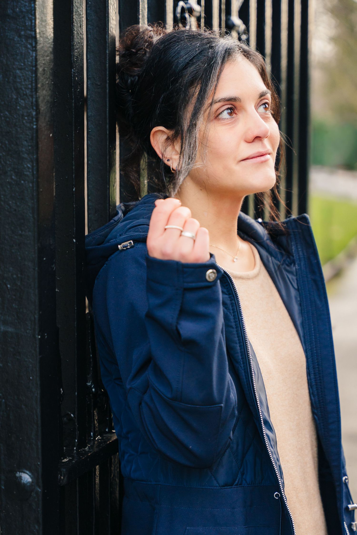 A series of artistic portrait shots showing someone in a navy blue jacket posing against a dark background. professional headshots dublin