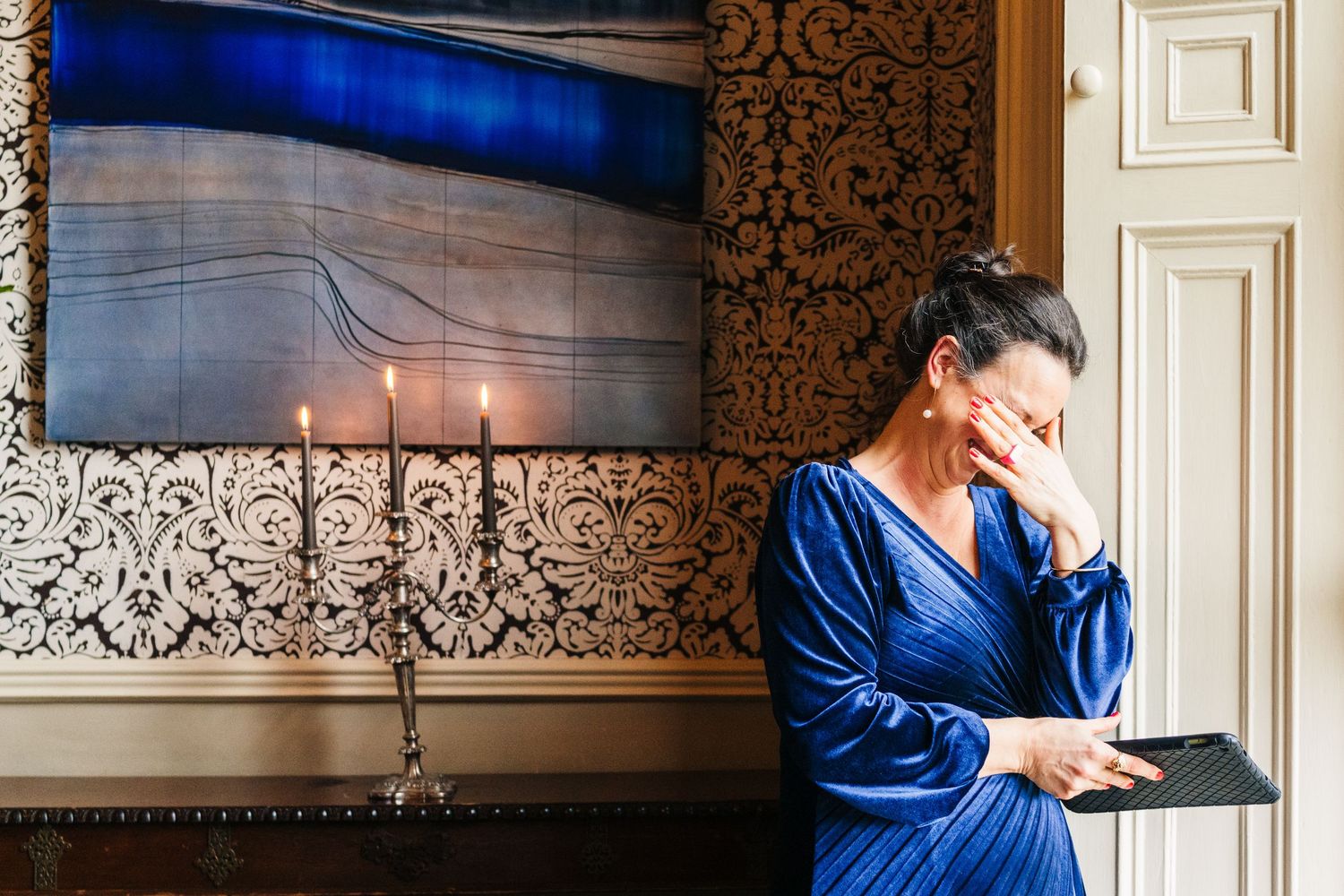 Wedding celebration in an ornate reception room with blue decor and elegant wall details.  Virginia Park Lodge Wedding Photographer Cavan Du
