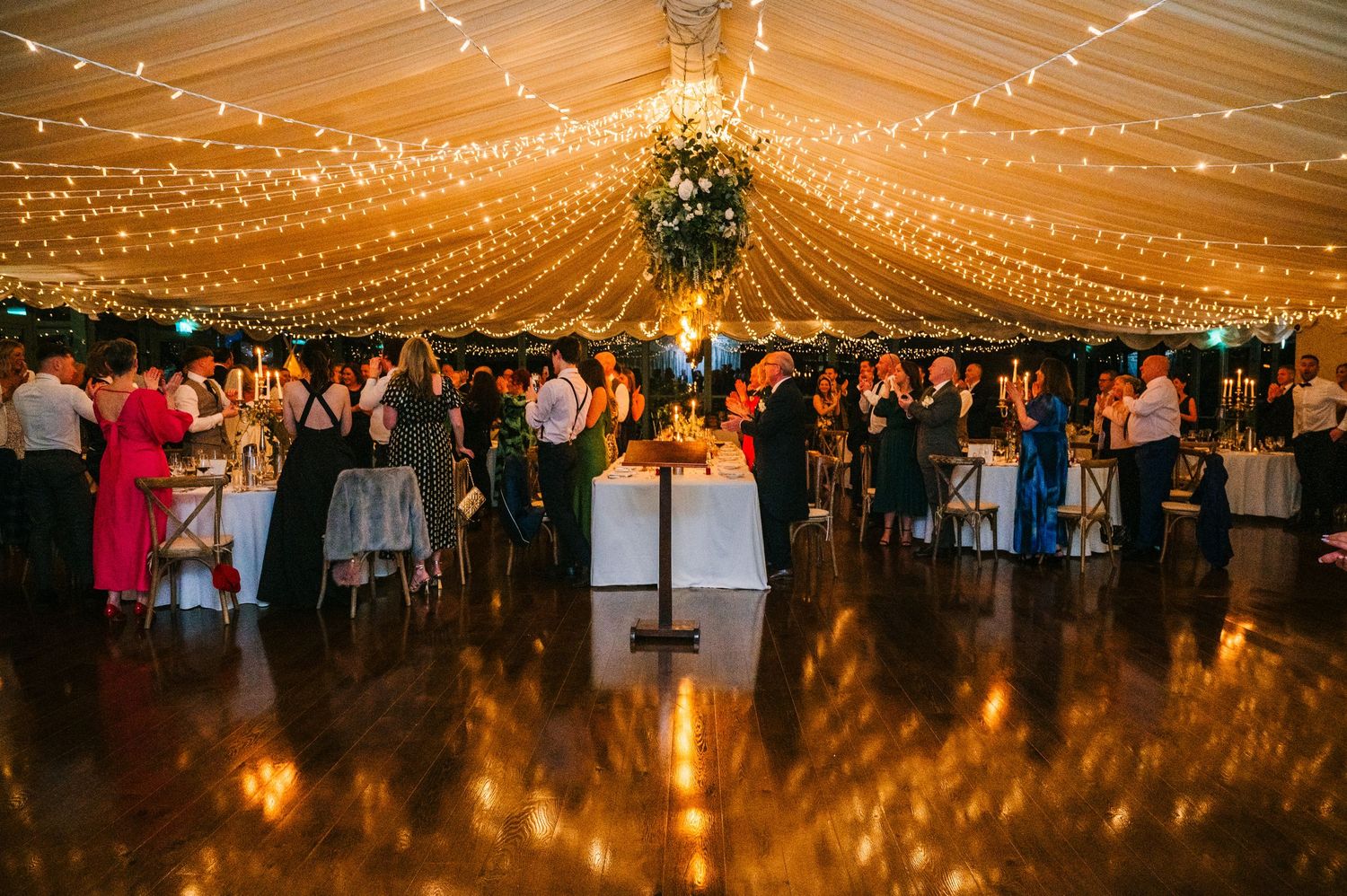 String lights create a magical canopy effect in a wedding reception tent at night.  Virginia Park Lodge Wedding Photographer Cavan Dublin Ir