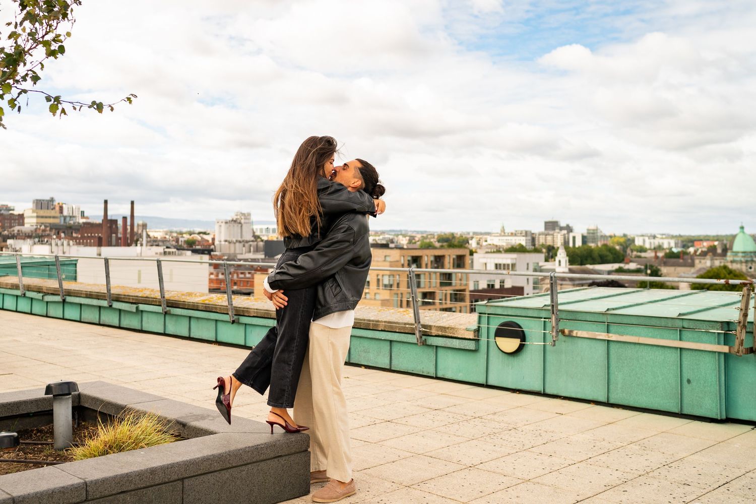 Rooftop cityscape scene with urban buildings and cloudy skies in the background. Couple's Photoshoot PHOTOGRAPHER Dublin