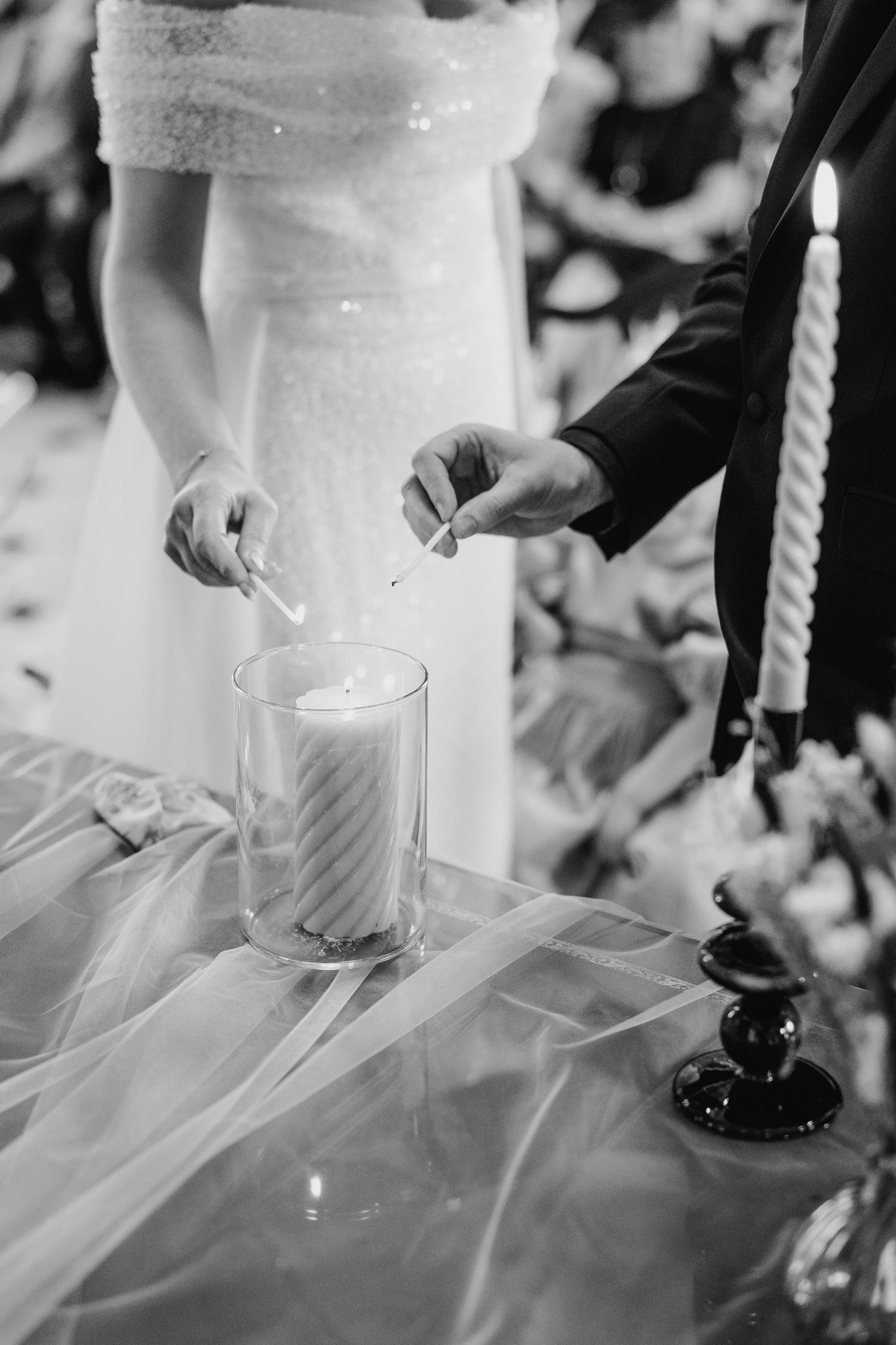 Close-up sequence of a unity candle lighting ceremony during a wedding with white tulle decorations.  city hall dublin wedding photos