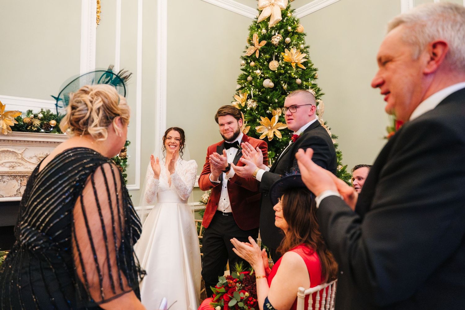 Wedding ceremony guests seated in chairs watching a special moment during an indoor celebration. Stephens green club dublin Wedding photogra