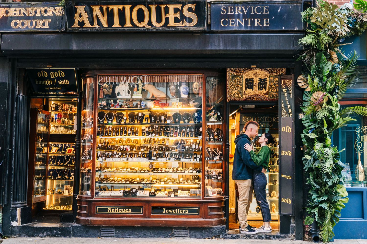 View of a vintage antique shop storefront with gold-framed window displays. PHOTOGRAPHER Dublin Ireland