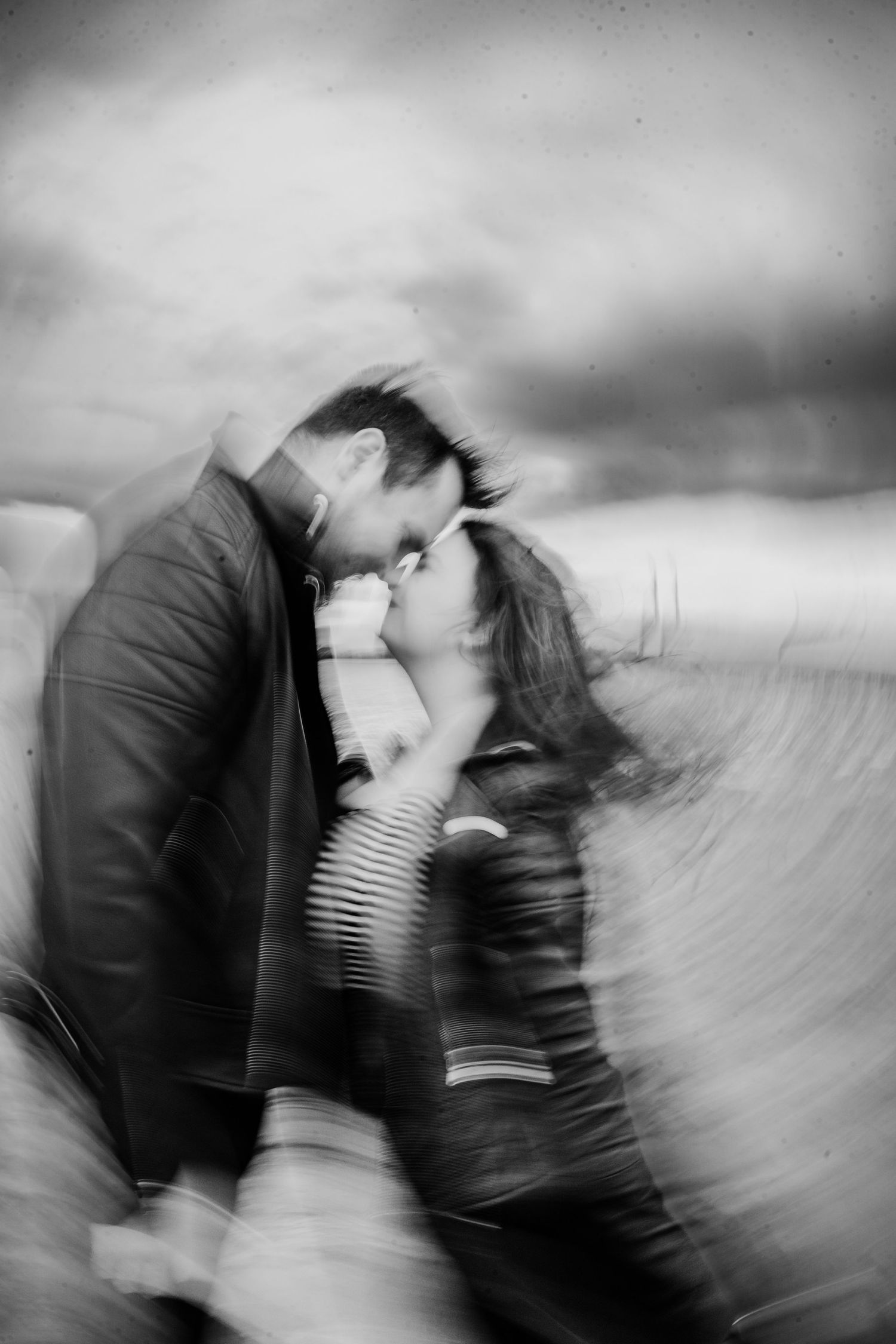 Artistic black and white photo sequence showing motion blur of two people in an intimate moment. engagement PHOTOGRAPHER Dublin