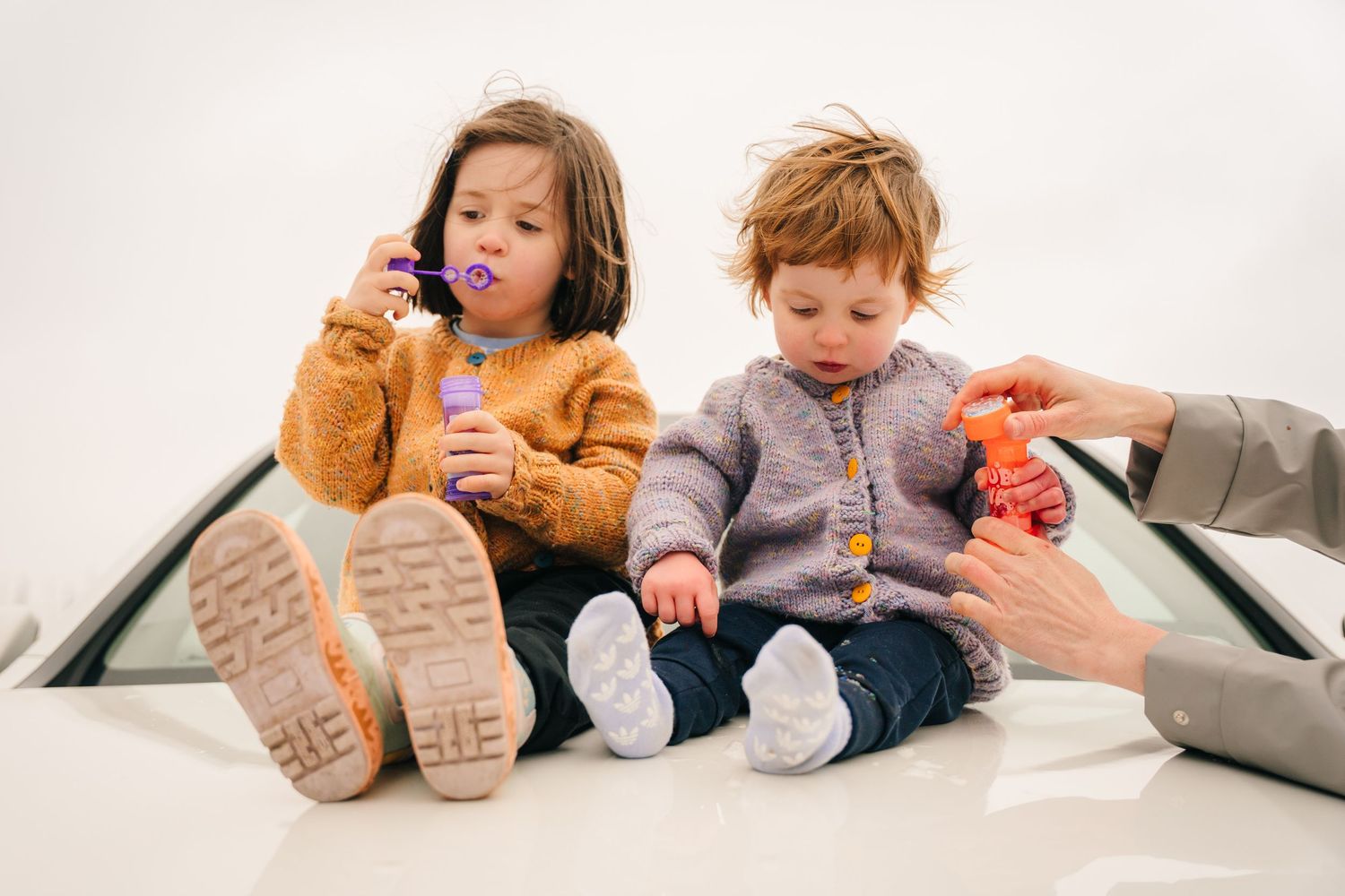 Children sitting together on a cozy couch while playing and interacting. PHOTOGRAPHER Dublin