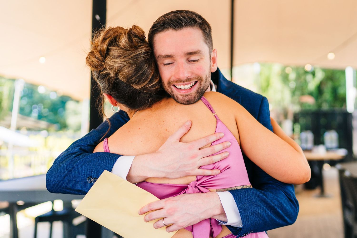 Poulaphouca Wedding photographer wicklow  Two people sharing a warm embrace at an outdoor celebration.