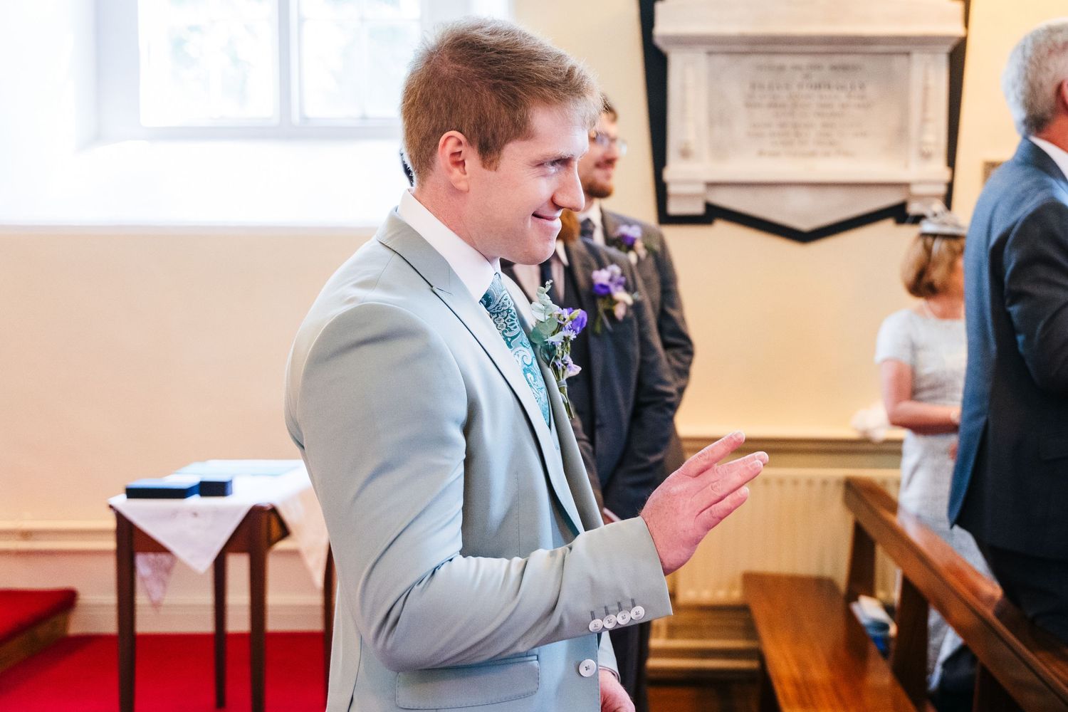 Millhouse slane wedding photographer dublin Wedding guests enjoying lively conversations in a brightly lit indoor venue.