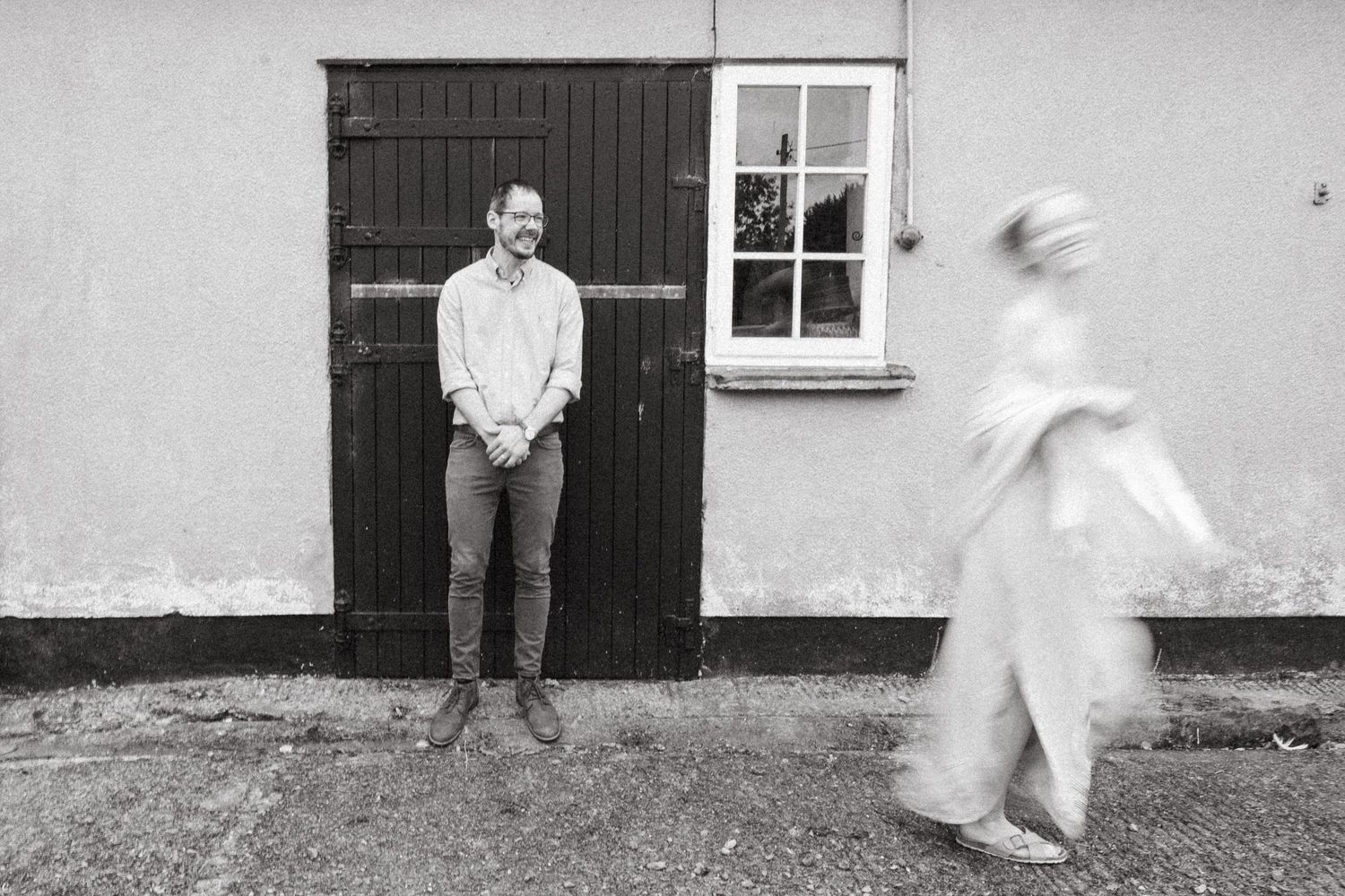 A black and white photo series showing blurred motion and static poses against a stark white wall and dark doorway. PHOTOGRAPHER Dublin irel