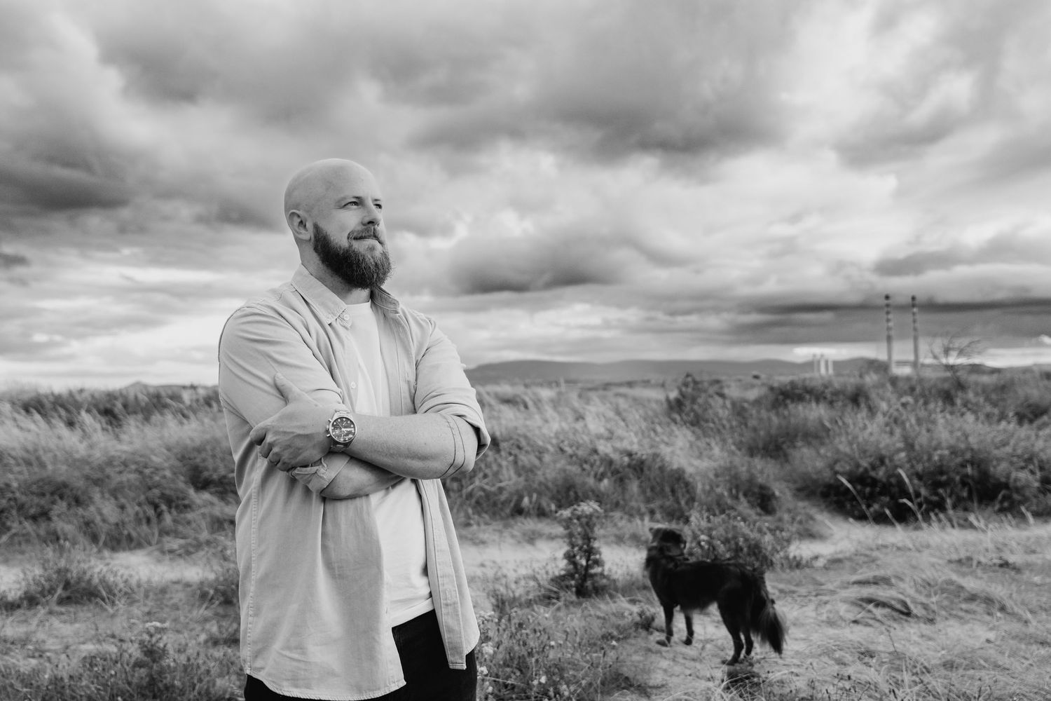 Black and white collage of seven outdoor landscape and portrait photos with dramatic cloudy skies and naturalistic settings. PHOTOGRAPHER Du