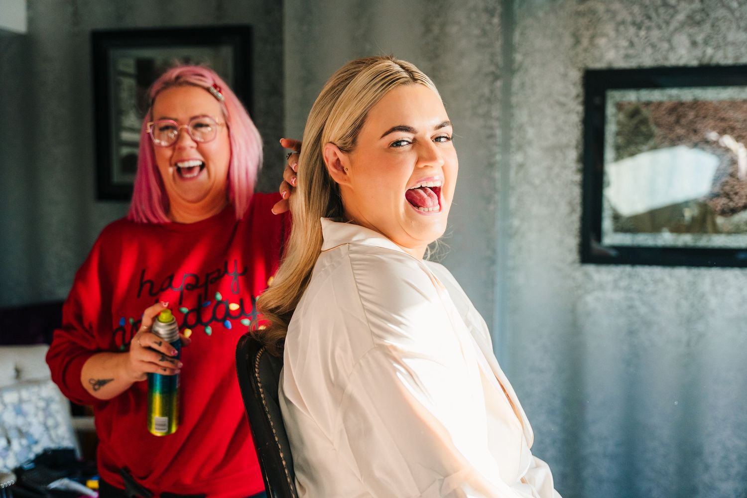 Two people laugh and embrace while posing together in a candid moment during a photo session. Wedding photographer dublin