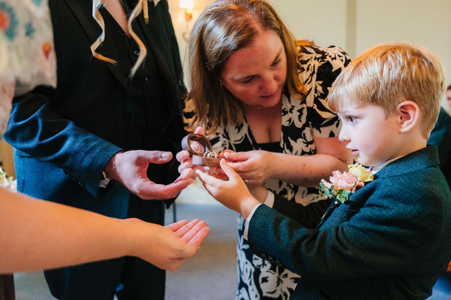 A tender moment during a wedding preparation as hands work together to secure a small detail. wedding photographer dublin