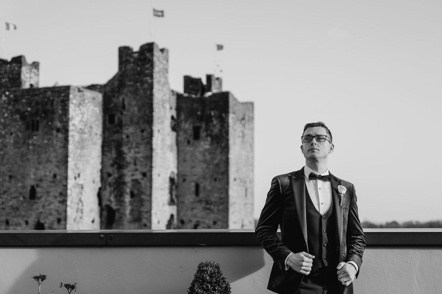 Historic castle ruins provide a dramatic backdrop for black and white wedding photography.  Wedding PHOTOGRAPHER Trim Castle