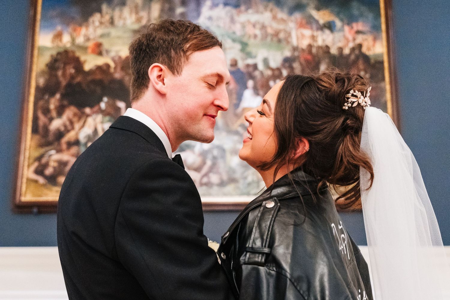 Romantic moment between newlyweds with vintage artwork in background. Wedding PHOTOGRAPHER Dublin