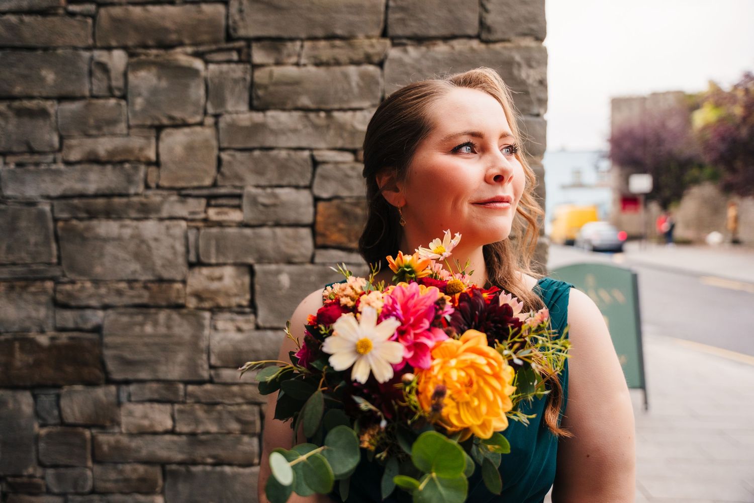 Vibrant bouquet of colorful flowers against a stone wall background. Wedding Photography Trim Castle Ireland