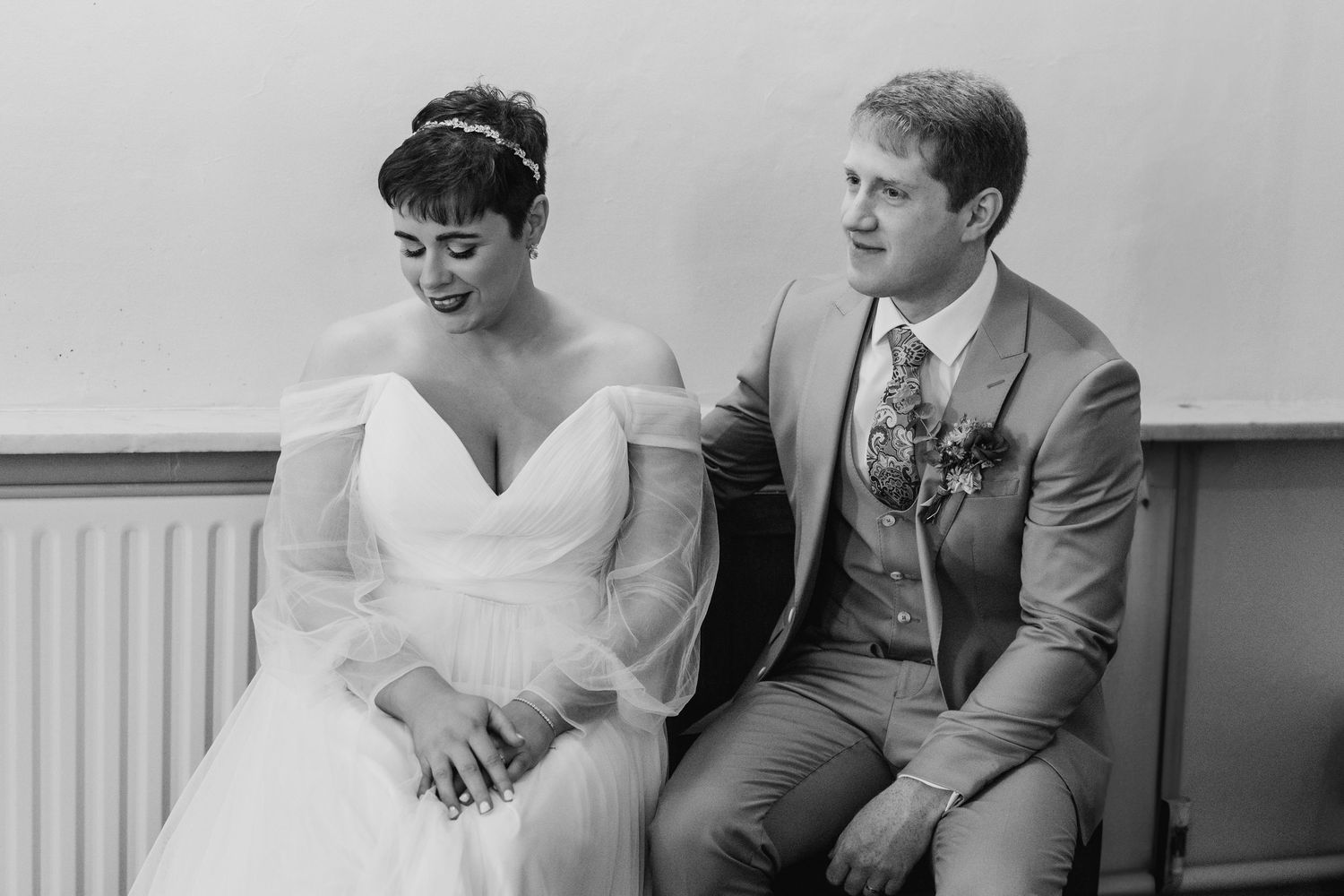 Millhouse slane wedding photographer dublin Black and white portrait in classic wedding attire against white wall.