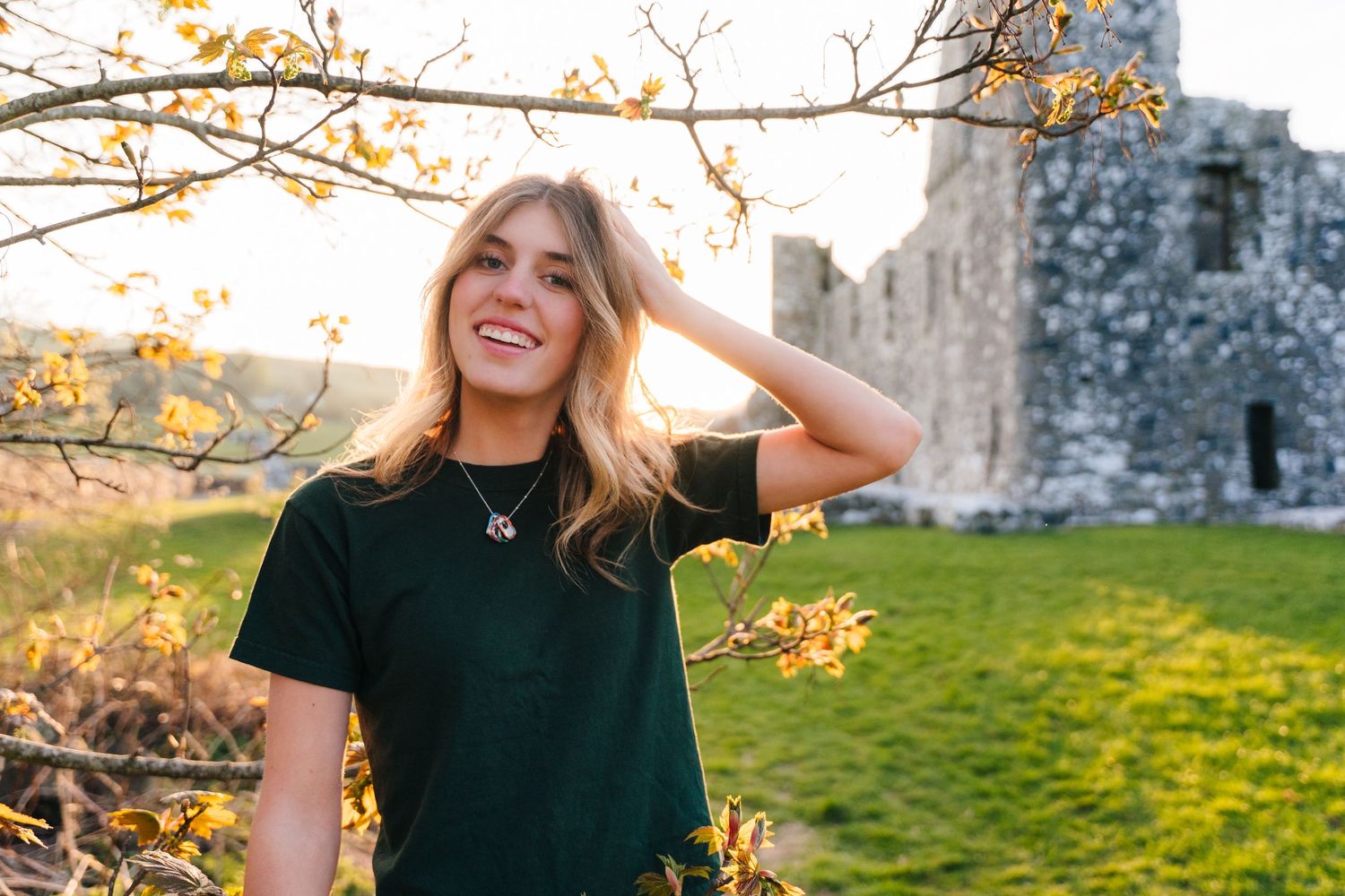 Sunset photoshoot near stone ruins with autumn branches framing the scene. Photographer Ireland dublin