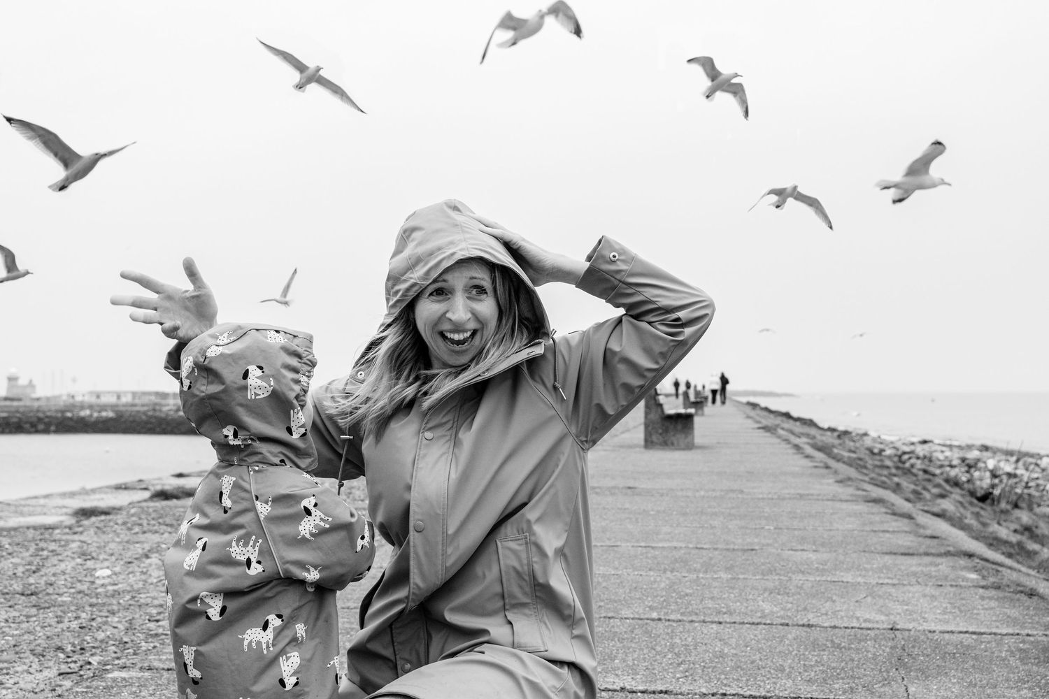 Laughter and joy on a windy pier with seagulls circling overhead. PHOTOGRAPHER Dublin