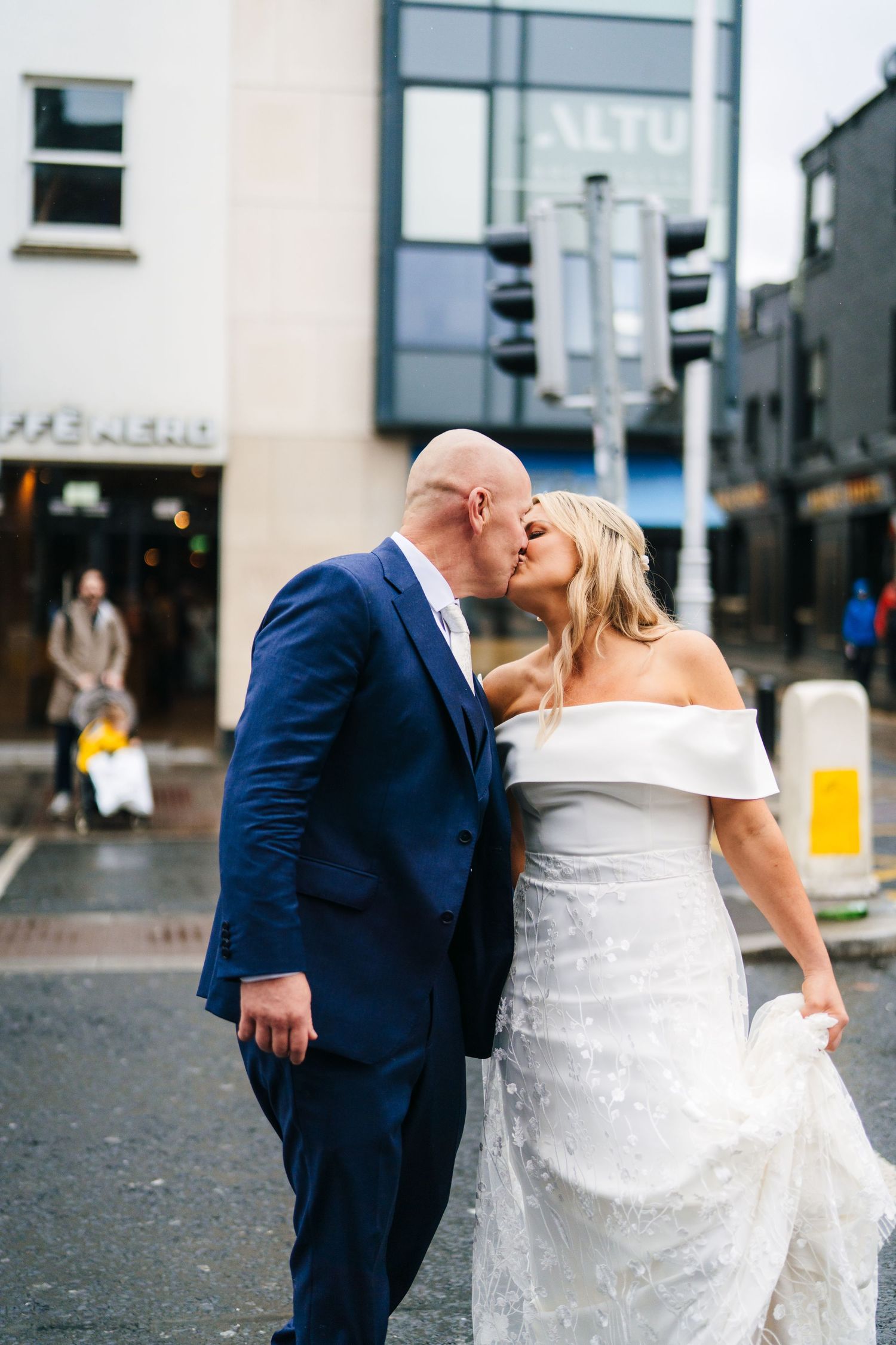 A series of romantic wedding photos showing a couple in navy suit and white gown dancing in an urban setting. The Dean Dublin Wedding Photog