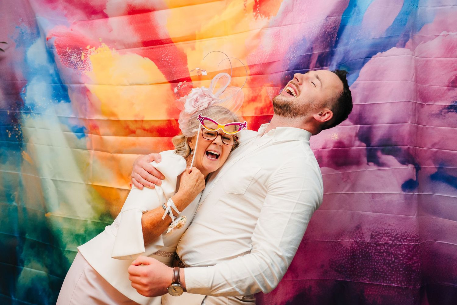 Colorful artistic photo against graffiti wall with vibrant orange, blue and purple hues. LGBTQ Ashley Park Wedding Photographer Dublin