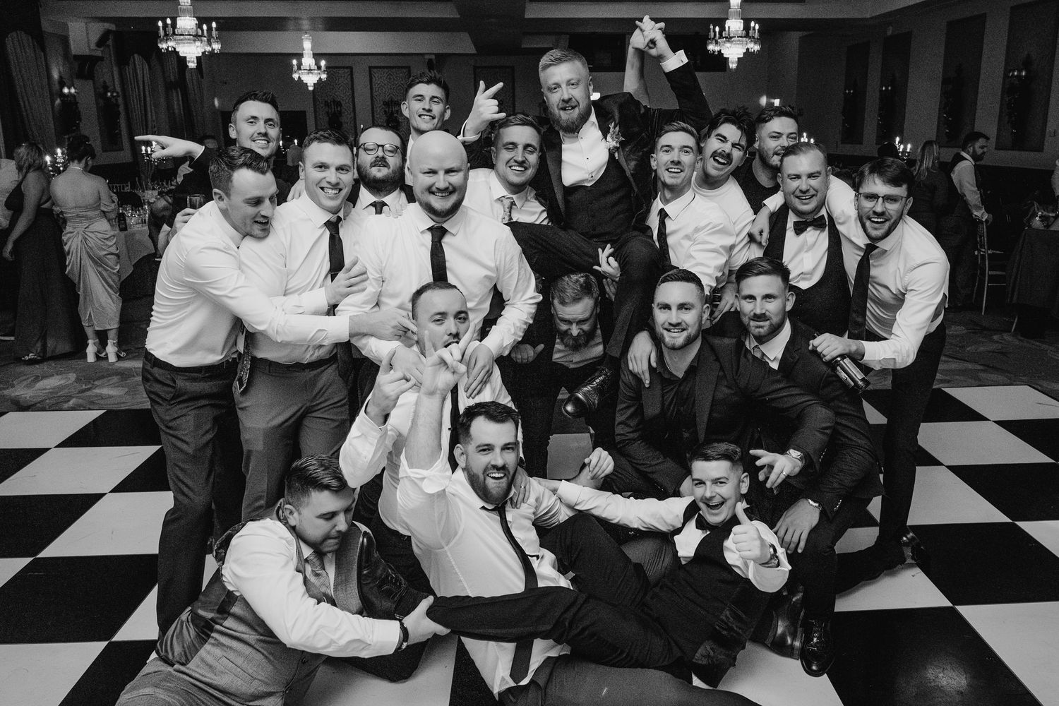 Black and white photo of wedding reception guests celebrating on dance floor. Wedding photographer dublin