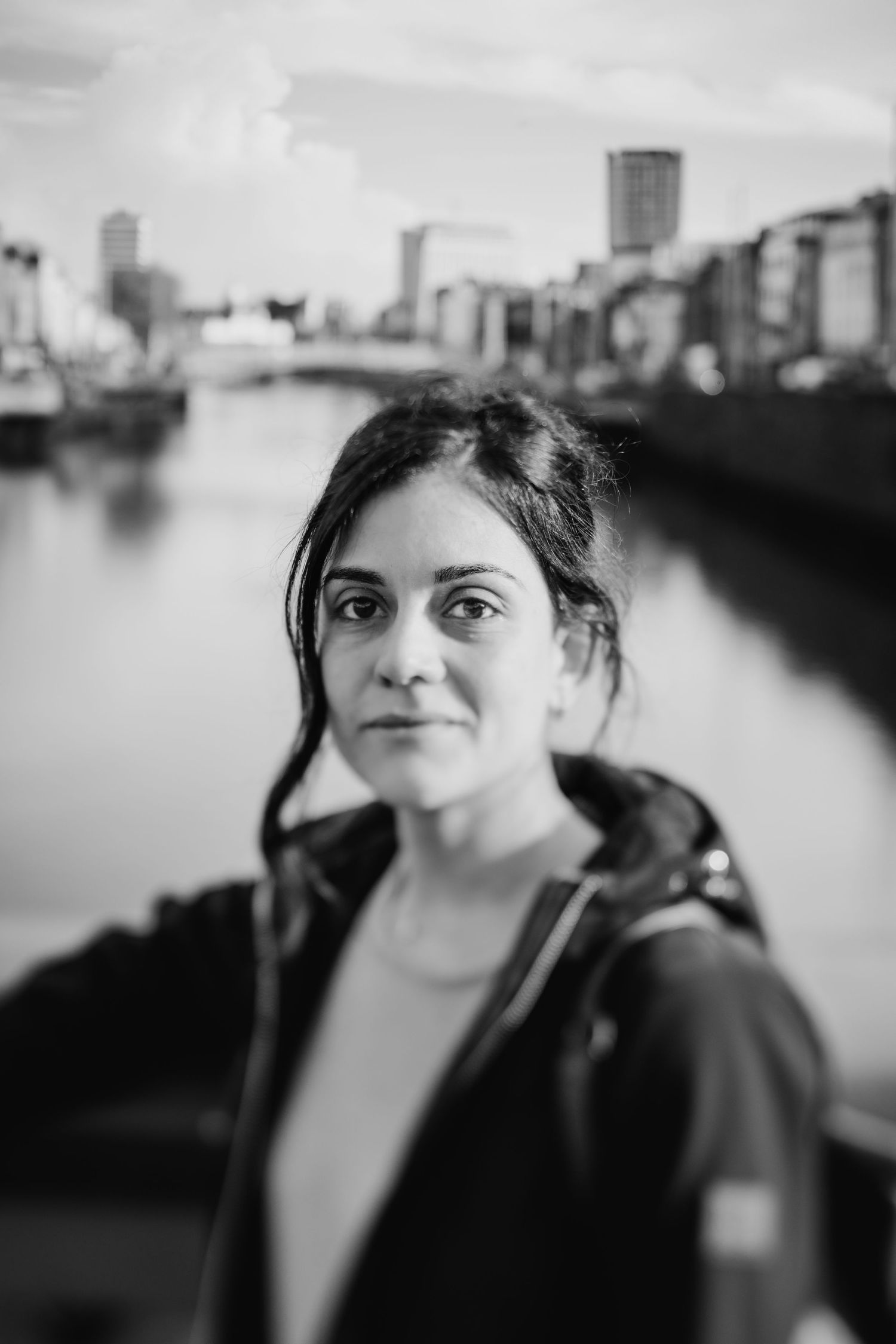 A sequence of black and white urban portraits with a cityscape visible in the background. professional headshots dublin