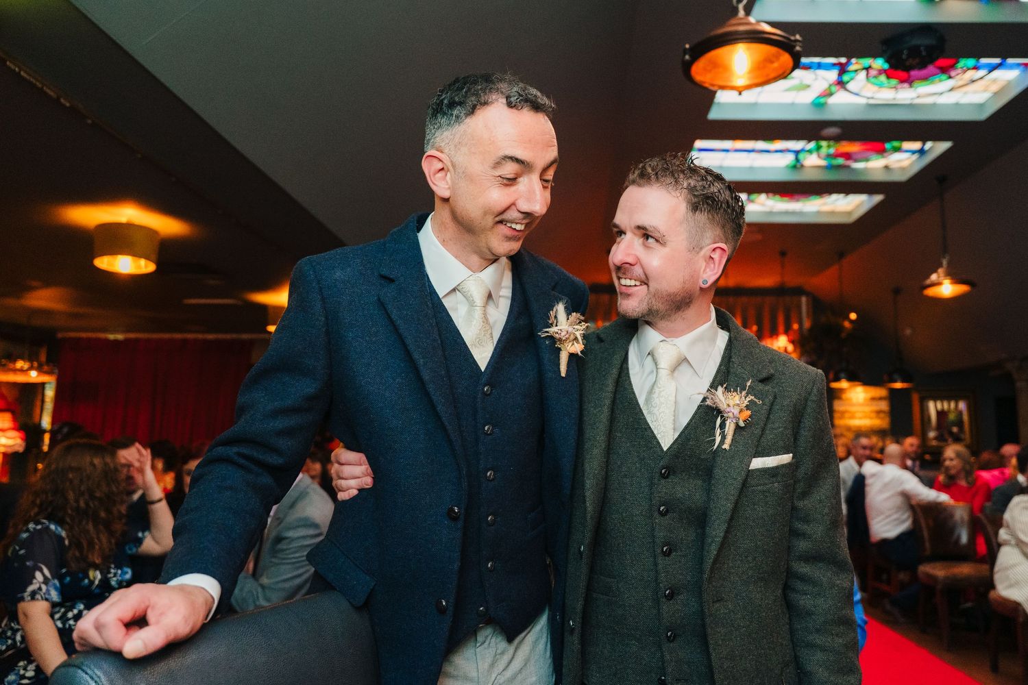 Sequence of candid moments between guests at an indoor reception with warm lighting.