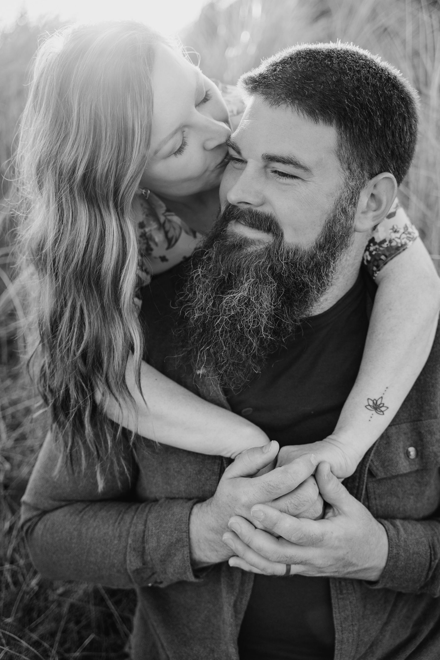 Intimate black and white portrait of a romantic embrace between a couple, with him sporting a full beard. PHOTOGRAPHER Dublin ireland