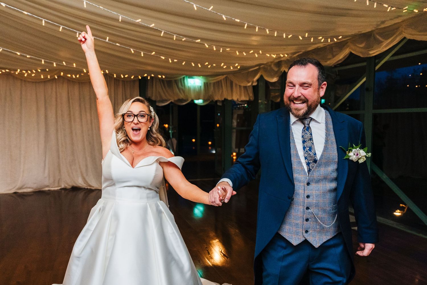 Joyful dance moves captured on the wedding reception dance floor under twinkling string lights. Wedding PHOTOGRAPHER Dublin