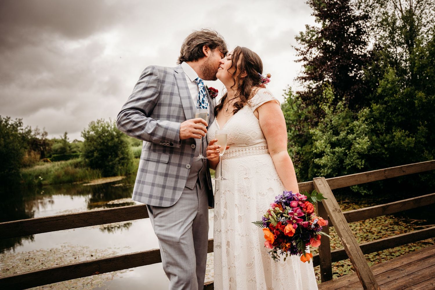 Romantic wedding photos captured on a cloudy day with rustic wooden fence backdrop. Wedding photographer Dublin