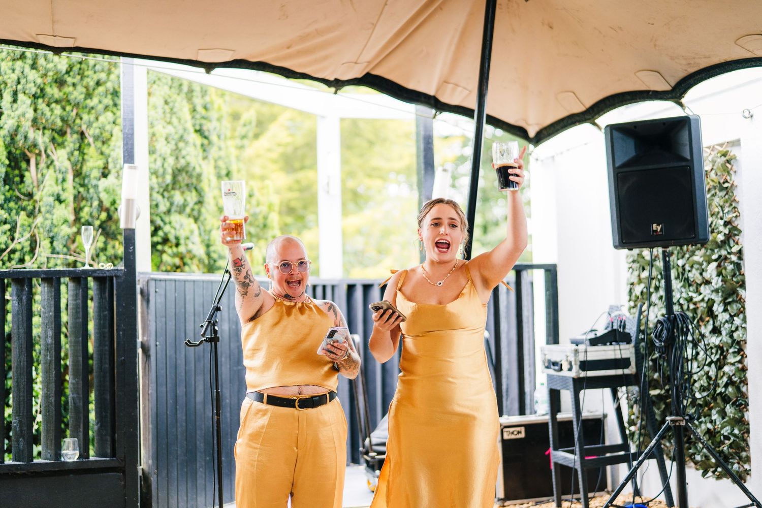 Poulaphouca Wedding photographer wicklow  Two performers in yellow outfits singing and dancing on an outdoor stage.