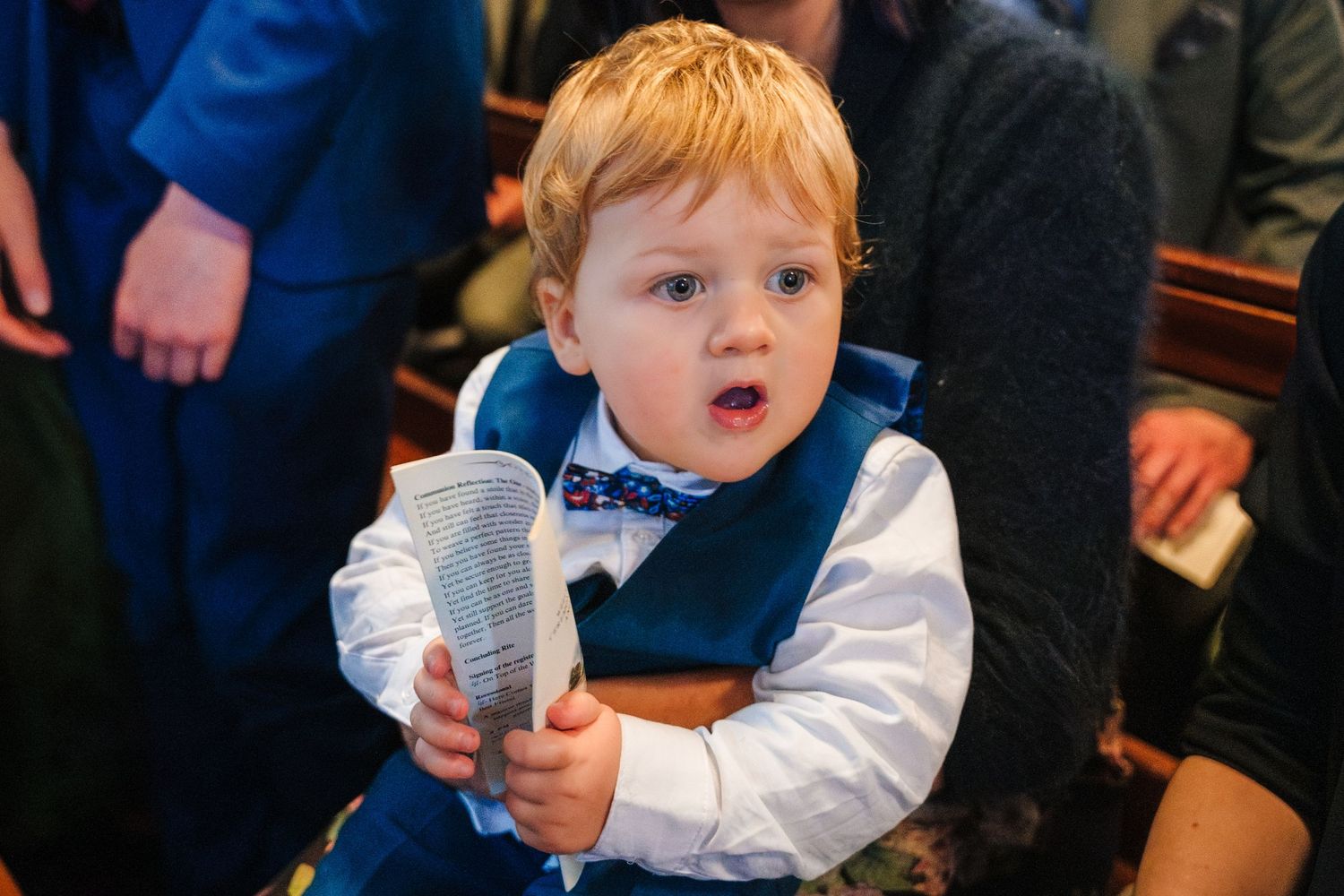 Small child in formal attire at wedding celebration.